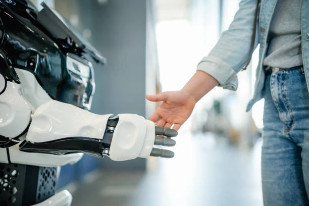 Human and robot handshake symbolizing human-AI collaboration